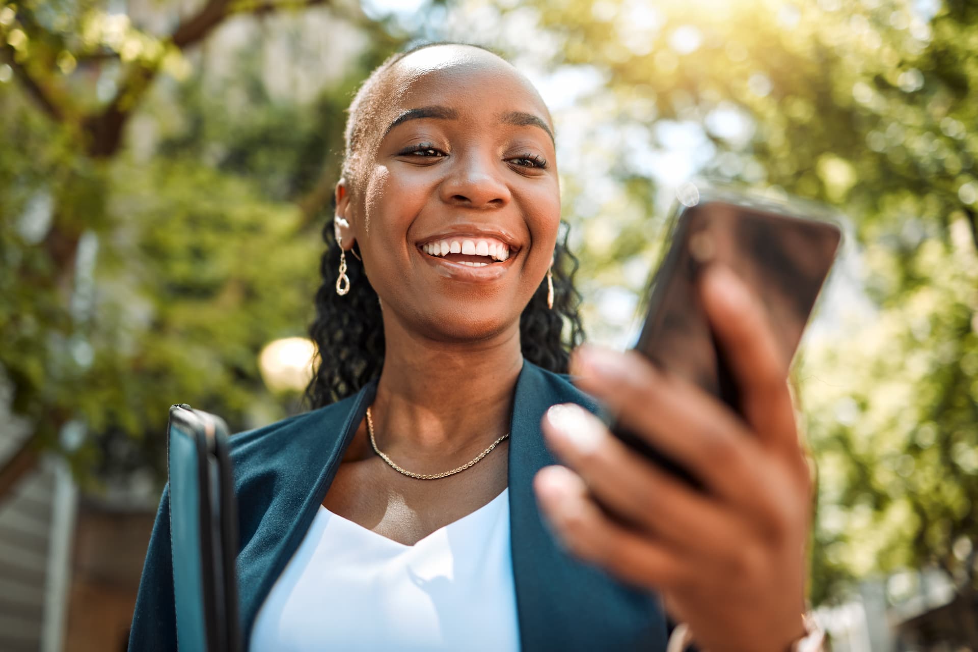 A happy woman shopping online on her phone, exploring products and making purchases