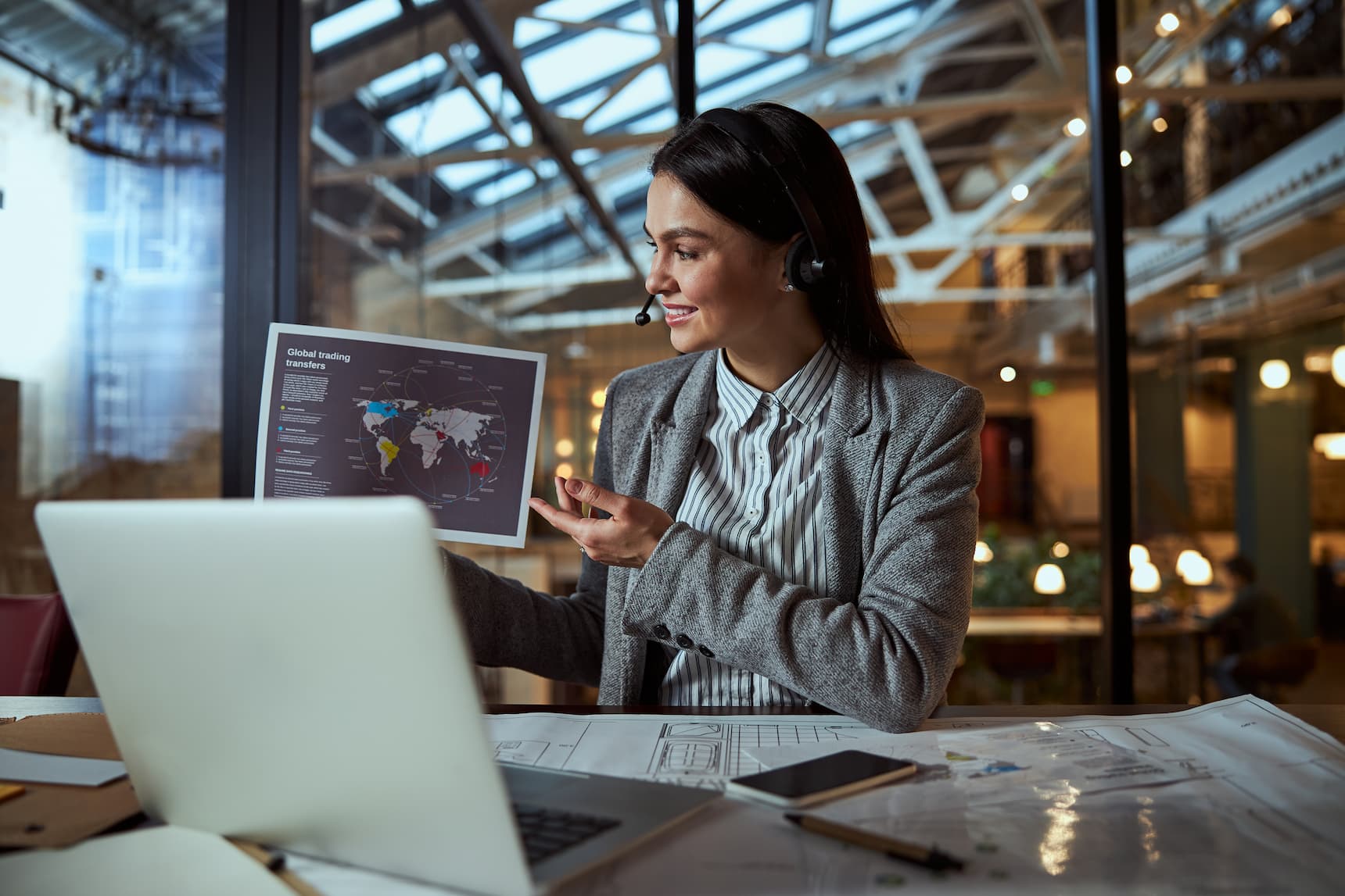 A female business executive wearing a headset, confidently leading a discussion, emphasizing leadership in customer service