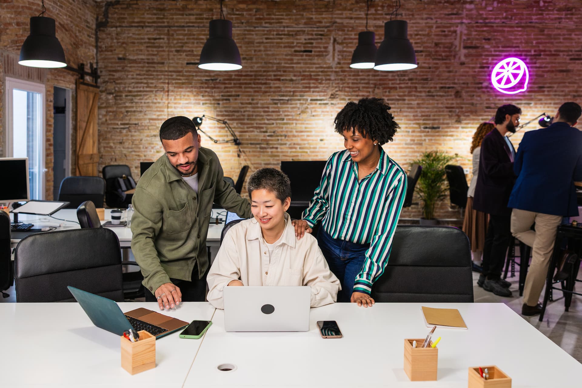 Multi ethnic team collaborating on laptop